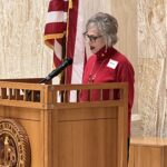 Annie Gilbert speaks at a Paid Family & Medical Leave press conference.