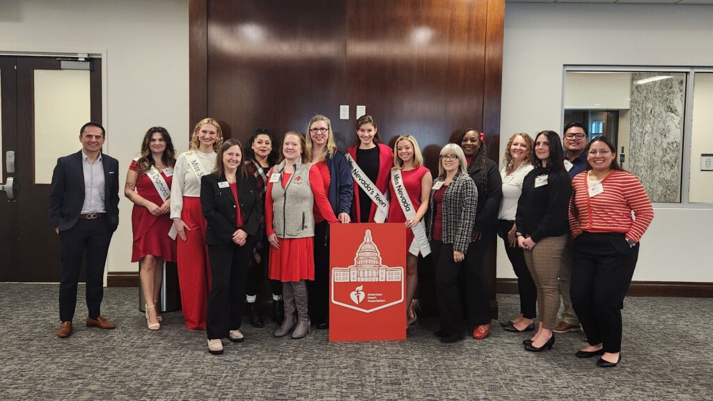 A group of people standing together inside a conference room.