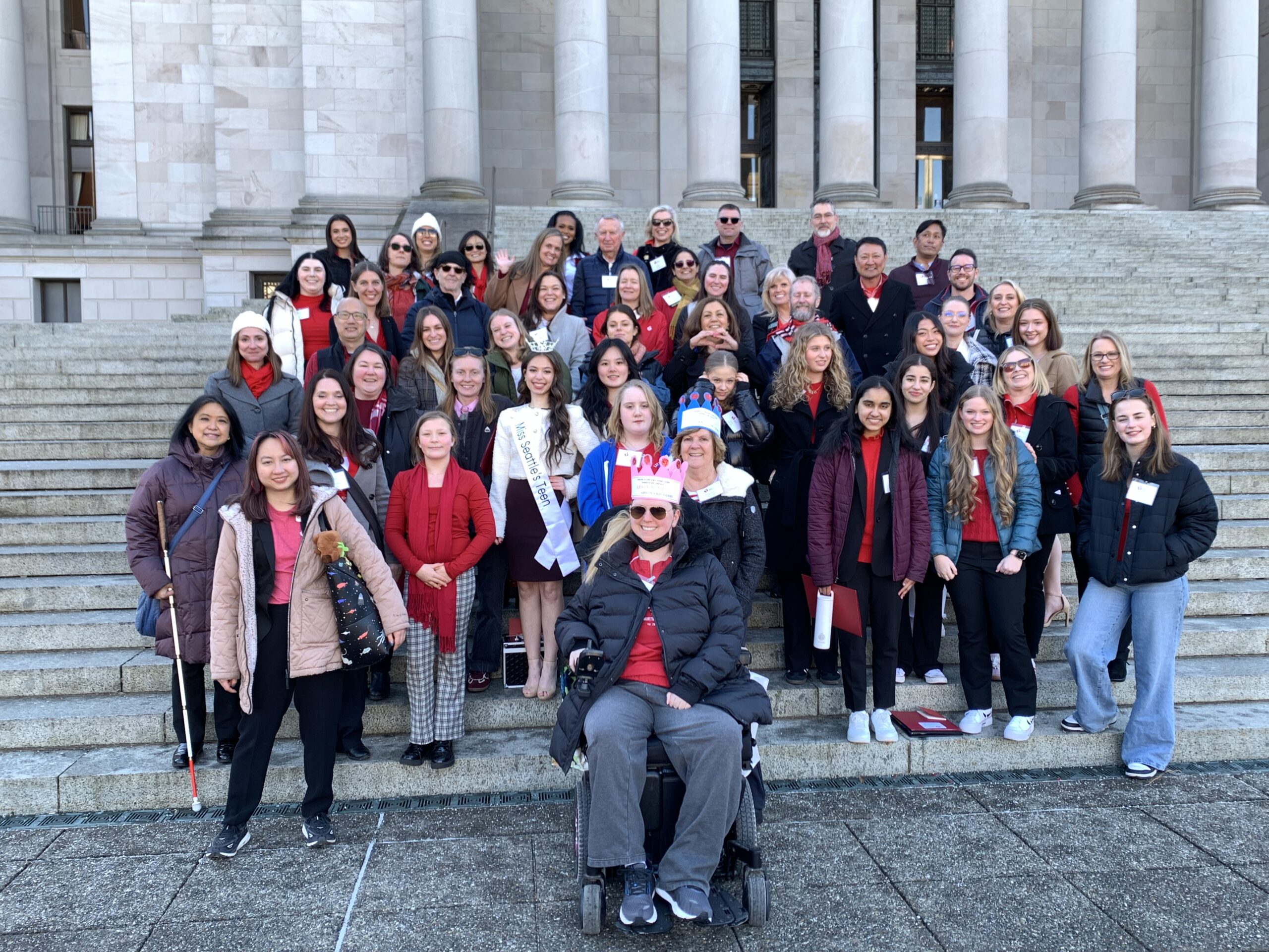 Advocates stand on the steps of the WA State Capitol building in Olympia