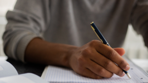 Person writing on paper.