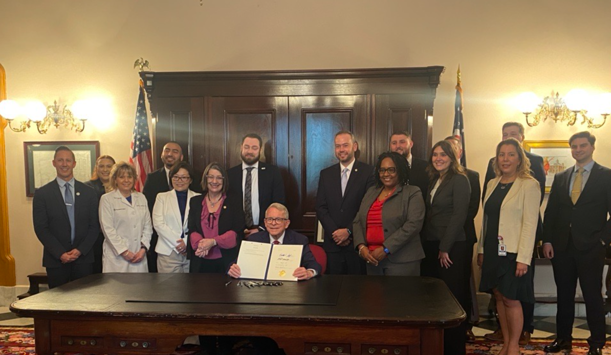 Heart Powered advocates take a photo with Governor Mike DeWine at the signing of Senate Bill 20.