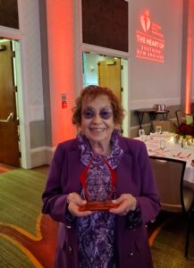 Miriam holding an award from the 2025 RI Heart Ball