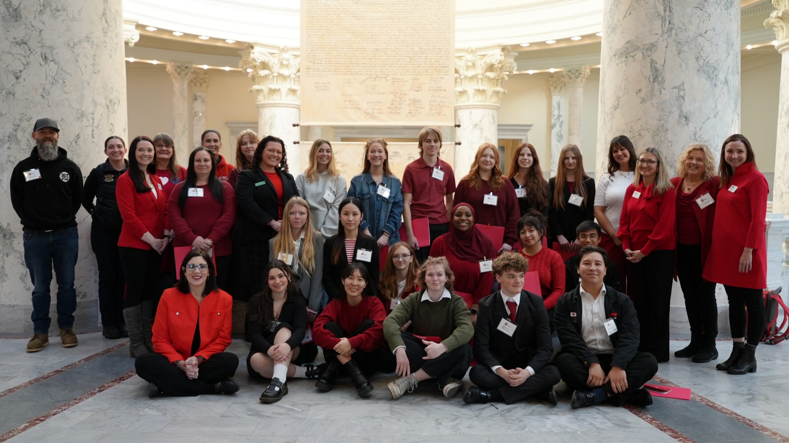 A group of people standing inside the Idaho state capitol building rotunda.