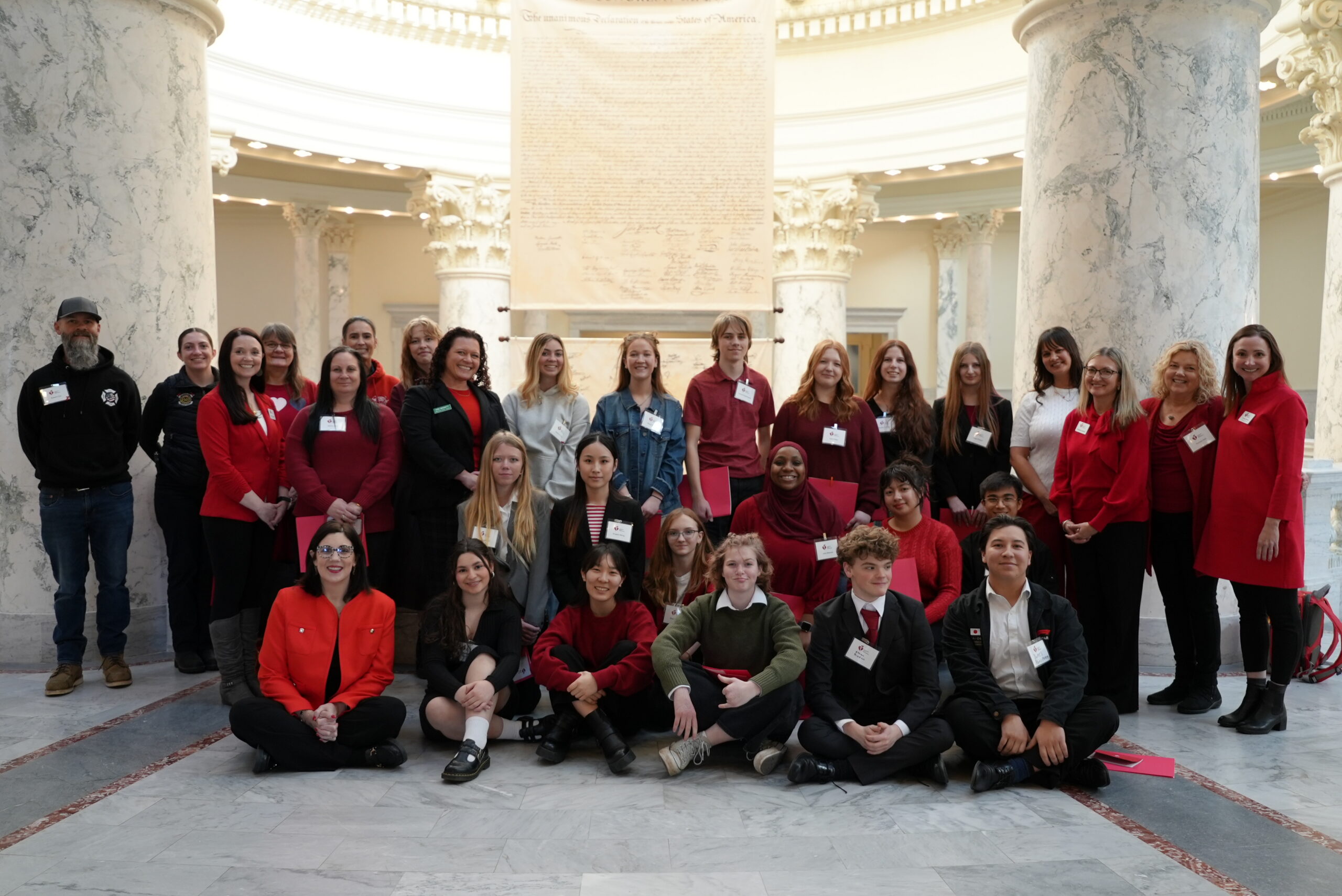 A group of people standing inside the Idaho capitol building.
