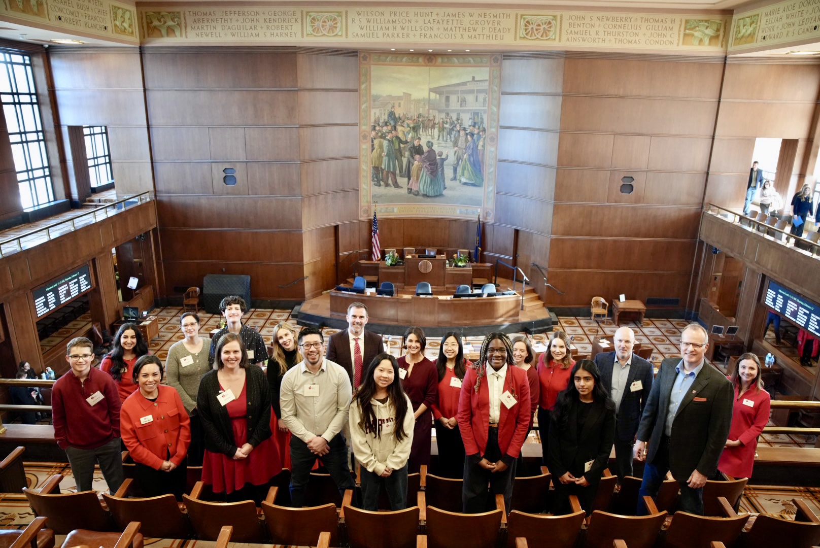 A group of people standing inside the legislative building.
