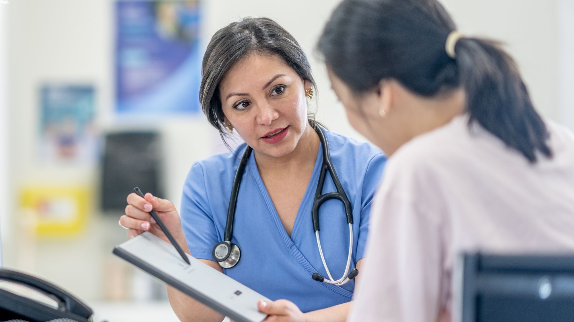 Picture of a nurse speaking to a patient.